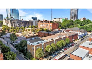 City view showing the building's exterior with surrounding buildings on a clear, sunny day at 320 W Martin St # 205, Raleigh, NC 27601