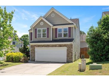 Two-story home with a two-car garage, stone accents, and charming curb appeal at 3566 Sunbright Ln, Raleigh, NC 27610
