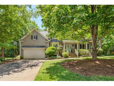 Charming two-story home with a covered front porch, manicured landscaping, and an attached two-car garage at 6 Gasper Ct, Durham, NC 27713
