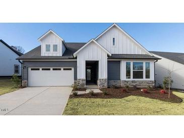 Charming two-story home with a two-car garage and manicured front yard at 61 Wabash Way, Pittsboro, NC 27312