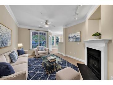 Inviting living room with plush seating, fireplace, and natural light streaming through the windows at 711 Providence Glen Dr, Chapel Hill, NC 27514