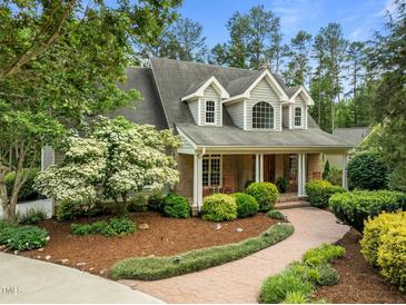 Charming home with inviting brick-and-siding facade and lush landscaping at 74002 Harvey, Chapel Hill, NC 27517