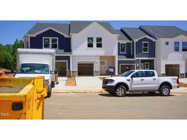 New construction townhomes featuring two-tone color schemes and attached garages at 1043 Winding Spring Dr, Mebane, NC 27302