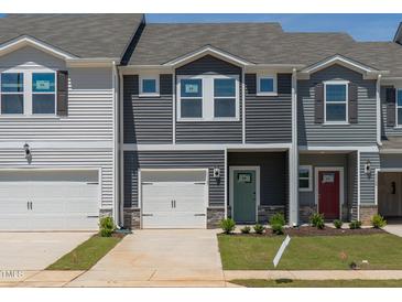 Charming townhomes with attached garages, and colorful front doors, creating a welcoming curb appeal at 1167 Abbott St, Mebane, NC 27302