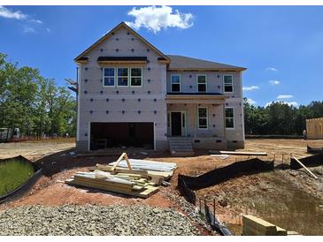 Unfinished two-story home featuring an attached two-car garage ready to be built on a lovely lot at 15 Guardian St, Youngsville, NC 27596