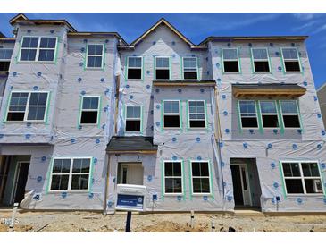 New construction townhome with a modern design and many windows in a desirable community at 348 Chesapeak Commons St # 137, Garner, NC 27529