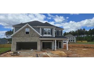 Two story home with a two-car garage and brick and vinyl siding at 40 Accord Dr, Youngsville, NC 27596