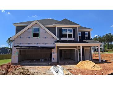 Exterior of a two-story home under construction, featuring a spacious open garage and classic architectural details at 40 Accord Dr, Youngsville, NC 27596
