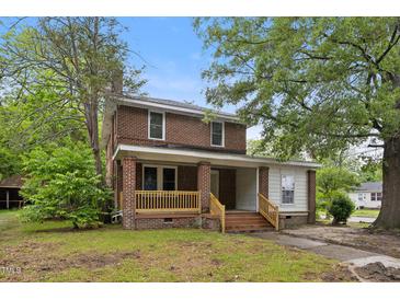 Charming two-story brick home with a welcoming front porch and mature trees at 500 Cokey Rd, Rocky Mount, NC 27801