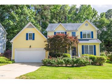Charming yellow two-story home featuring blue shutters and a well-manicured front lawn at 5417 Harrington Grove Dr, Raleigh, NC 27613