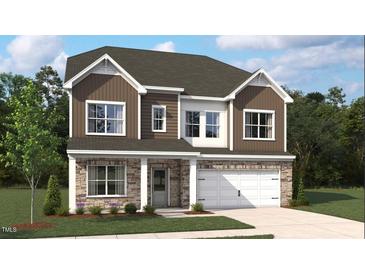 Charming two-story home featuring a stone facade, brown siding, white trim, and an attached two car garage at 556 Jocund St # 13, Rolesville, NC 27571