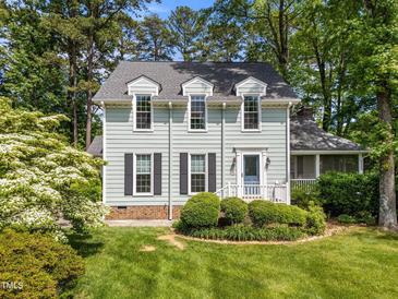 Charming two-story home with light-green siding, dormer windows, dark shutters, and a well-manicured front yard at 6420 Dresden Ln, Raleigh, NC 27612