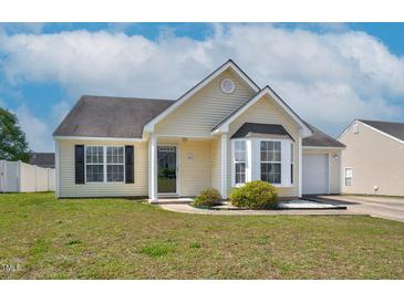 Charming single-story home featuring a bay window, manicured lawn, and attached one car garage at 6921 Peppermill Way, Rocky Mount, NC 27804