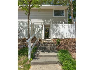 Inviting two-story home featuring well-maintained front yard and a charming walkway to the front door at 7177 Sandy Creek Dr, Raleigh, NC 27615