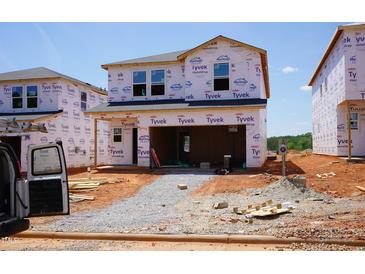 Exterior view of a home under construction, featuring Tyvek HomeWrap and a rough-graded yard at 836 Ottawa Dr, Garner, NC 27529