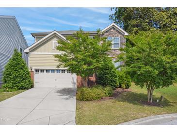 Charming two-story home with stone and siding, landscaped yard and two-car garage at 1009 Magnolia Leaf Ct, Apex, NC 27502