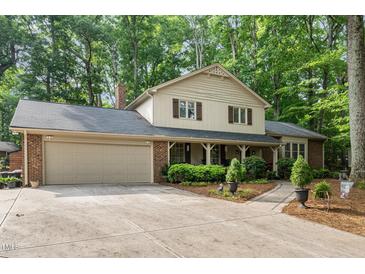 Charming home featuring a front porch, brick accents and a spacious two-car garage at 125 Amesbury Ln, Cary, NC 27511