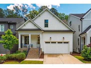 Charming home with white siding, well-manicured lawn, and a welcoming two-car garage at 151 Monteith Dr, Chapel Hill, NC 27516