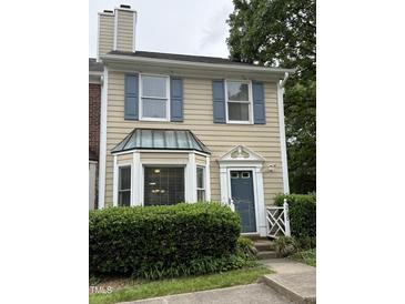 Charming townhome with blue shutters, bay window, and well-maintained landscaping at 210 Standish Dr Dr, Chapel Hill, NC 27517