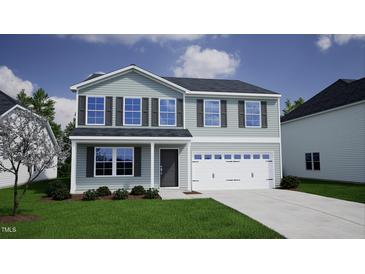 Charming two-story home featuring a well-manicured lawn and a two-car garage at 24 Grove Township Way, Angier, NC 27501