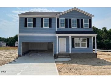 Charming two-story home featuring a spacious two-car garage and classic architectural design at 24 Grove Township Way, Angier, NC 27501