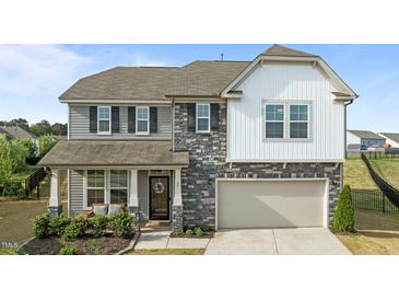 Charming two-story home with a blend of stone and siding accents, plus a two-car garage at 25 Gallery Park Dr, Franklinton, NC 27525