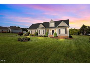 Charming single-story home with a beautifully manicured lawn and mature landscaping at 281 Derwin Dr, Timberlake, NC 27583