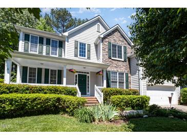 Charming two-story home featuring a welcoming front porch, stone accents, and lush landscaping at 4608 Regency Dr, Durham, NC 27713