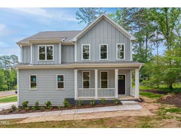 Charming two-story home with a welcoming front porch and gray siding at 509 Olive Branch Rd, Durham, NC 27703