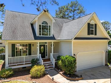 Charming two-story home with a landscaped front yard, covered porch, and attached two-car garage at 6513 Cablewood Dr, Raleigh, NC 27603