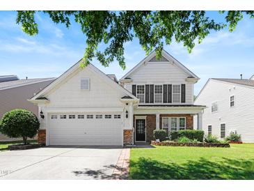 Charming two-story home with a two-car garage and well-manicured front lawn at 1005 Fulbright Dr, Morrisville, NC 27560