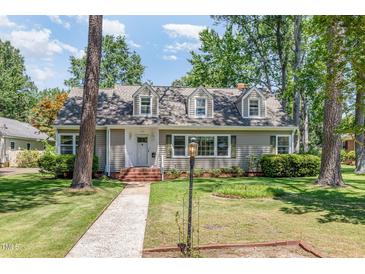Charming two-story home with a landscaped front yard and dormer windows at 103 E Meadowbrook Dr, Smithfield, NC 27577