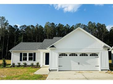 Charming single-Gathering home featuring a two-car garage, landscaped yard, and classic exterior design at 107 Earnest Way, Kenly, NC 27542
