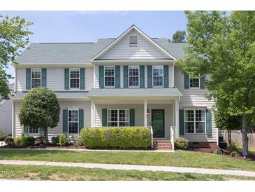 Charming two-story home featuring light siding, green shutters, a manicured lawn and mature landscaping at 110 Stoney Dr, Durham, NC 27703