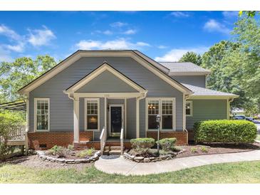 Charming home with a well-maintained lawn, beautiful landscaping, and a welcoming front entrance at 1201 Red Beech Ct, Raleigh, NC 27614