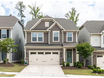 Charming two-story home with a two-car garage and landscaped front yard at 1380 Channing Park Cir, Cary, NC 27519