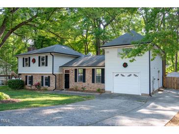 Charming two-story home featuring brick accents, light siding, attached garage and a well-maintained lawn at 1700 Laura Duncan Rd, Apex, NC 27502