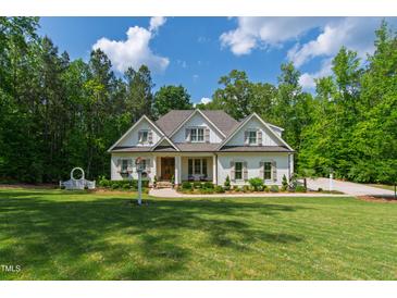 Charming two-story home with landscaped front yard and walkway to a covered porch at 197 Boxwood Dr, Pittsboro, NC 27312