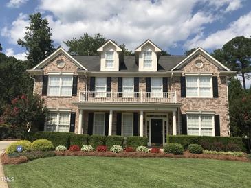 Charming two-story brick home with a manicured lawn and beautiful landscaping at 210 Shillings Chase Dr, Cary, NC 27518
