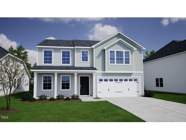 Charming two-story home featuring a light gray and blue color scheme, a two-car garage, and a well-manicured lawn at 248 Alice Trace Place, Angier, NC 27501