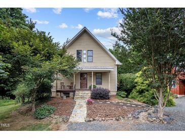 Charming home featuring a stone walkway and a cozy front porch with chairs at 260 Woody Ln, Oxford, NC 27565