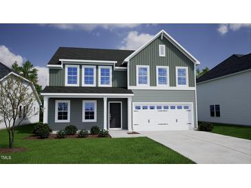 Two-story home boasts a tidy lawn, attached garage, and neutral siding under a blue sky at 294 Alice Trace Place, Angier, NC 27501