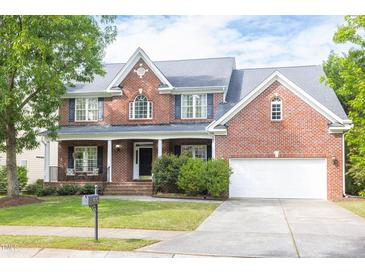 Charming two-story brick home with landscaped yard and attached two car garage at 4913 Stockton Way, Durham, NC 27707
