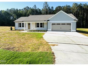 Charming single-story home featuring a two-car garage and inviting front yard at 71 Earnest Way, Kenly, NC 27542