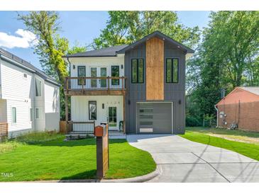 Striking two-story home with a modern design, mixed siding, a front-facing two-car garage, and a well-maintained lawn at 1124 Upchurch St, Raleigh, NC 27610
