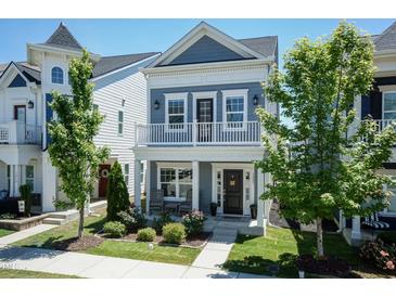 Charming two-story home with a balcony, landscaped yard, and inviting curb appeal at 1223 Brown Velvet Ln, Apex, NC 27523