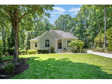 Inviting single-story home with well-maintained landscaping and a charming facade at 12733 Pamplona Dr, Wake Forest, NC 27587