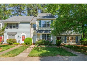Charming townhome with manicured lawn and colorful flowerbeds enhancing its curb appeal at 1316 Garden Crest Cir, Raleigh, NC 27609