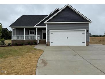 Charming single-Gathering home boasts a two-car garage, covered porch and low-maintenance landscaping at 134 Royal Ave, Selma, NC 27576