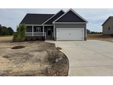Charming single-Gathering home with a two-car garage and a well-manicured lawn in a residential area at 134 Royal Ave, Selma, NC 27576